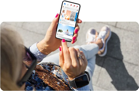 View from above of lady, outdoors, using social app on a smartphone.